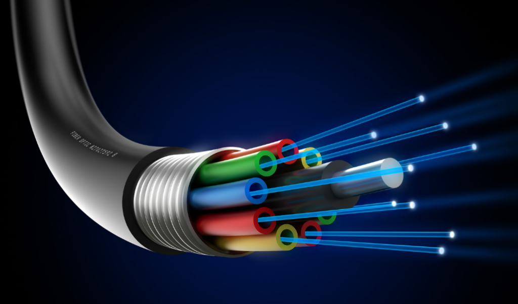 Close-up of a cut-open fiber optic cable against a dark blue background. The cable shows multiple colorful internal wires and glowing blue light beams extending outward, illustrating data transmission.